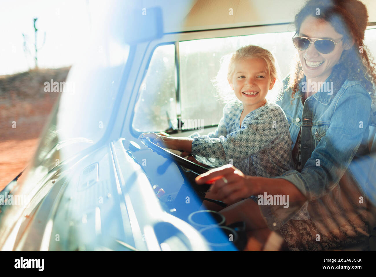 Happy mother and daughter driving van Stock Photo