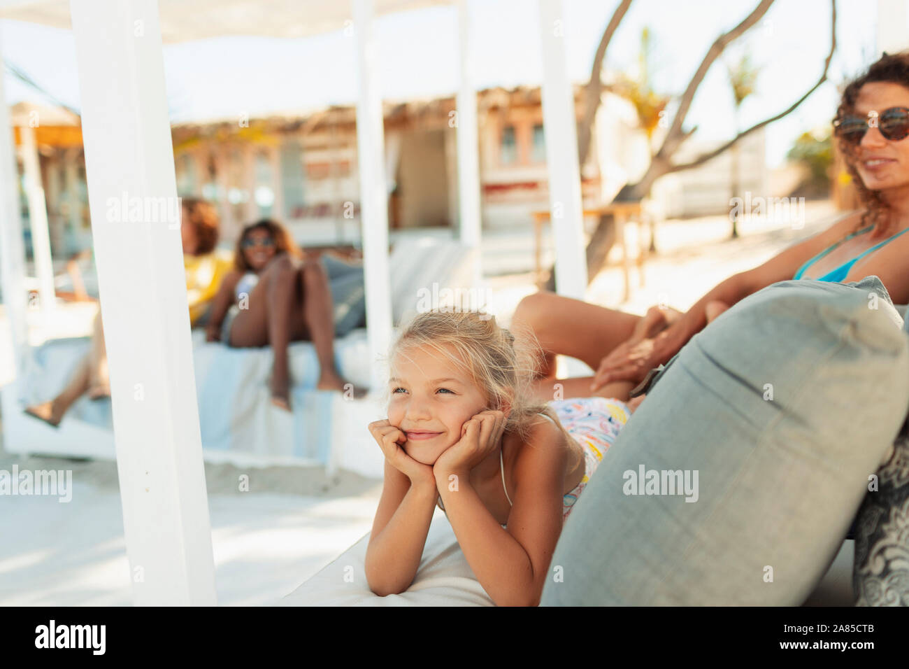 Carefree girl relaxing on beach patio Stock Photo