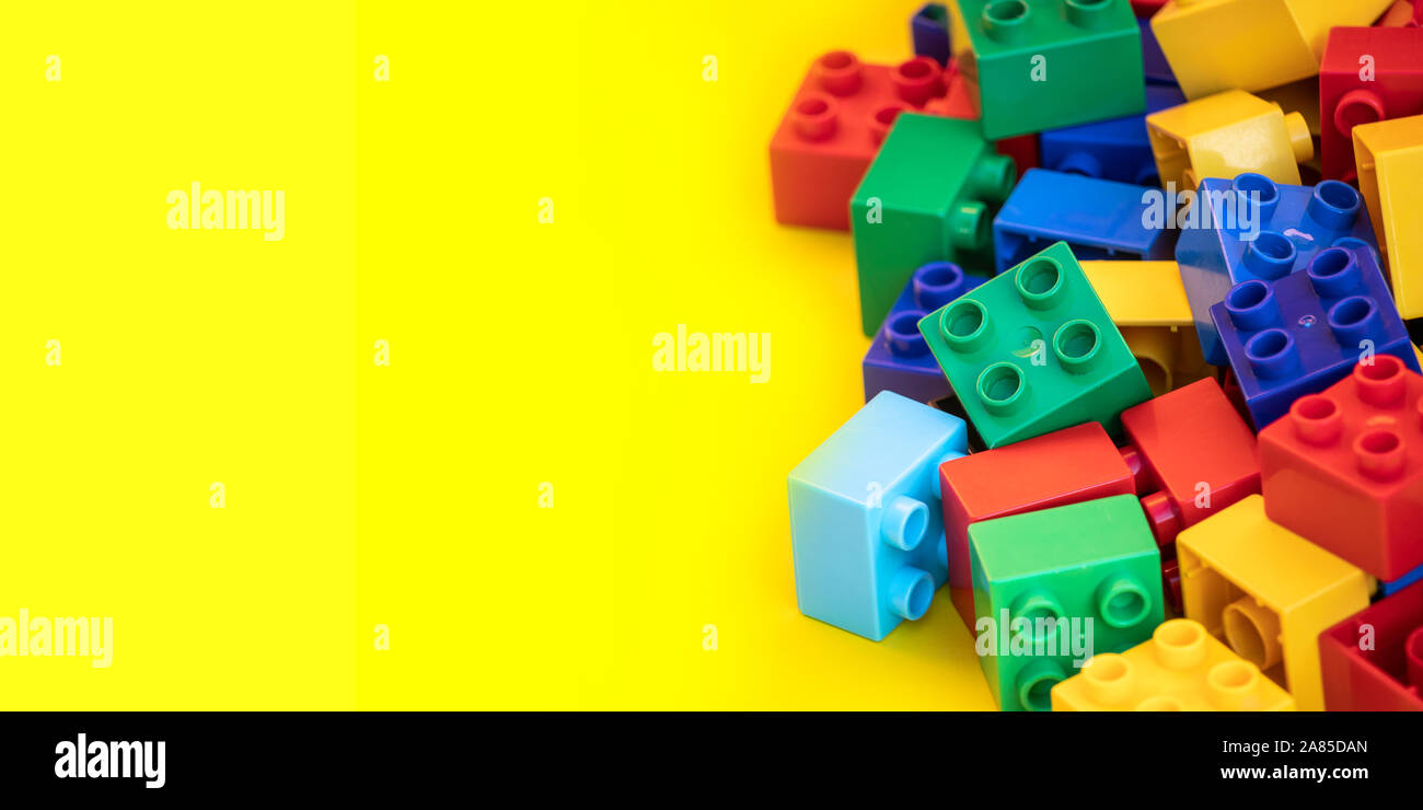 Colorful plastic building blocks toy bricks with place for you text and