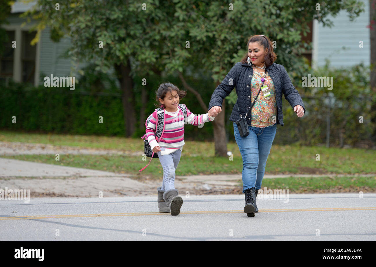 Yanira Lopez walks her daughter Melany home from school in San Antonio, Texas.. Lopez and her three children fled Guatemala for asylum in the US. Stock Photo