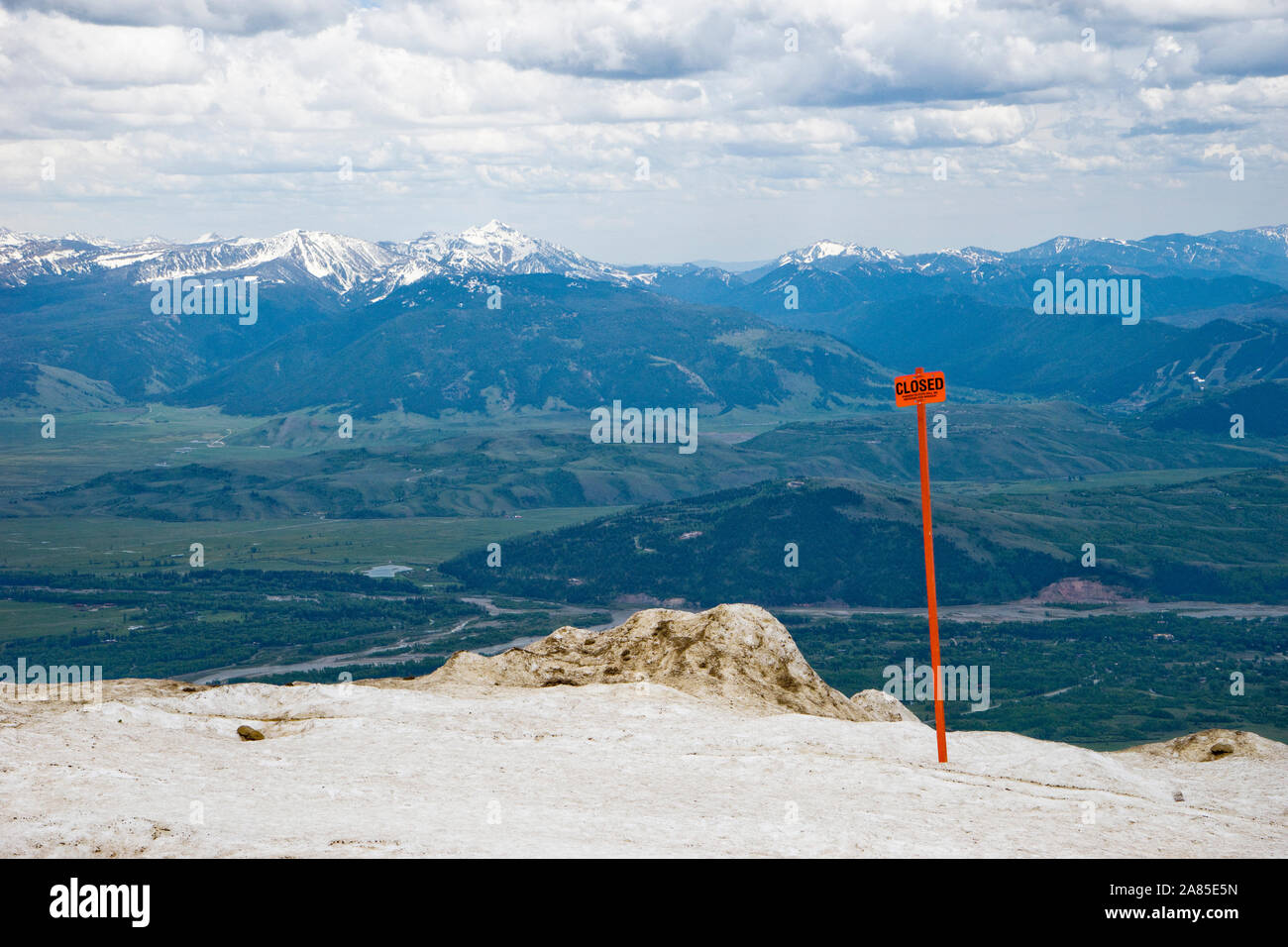 Closed sign in the snow at Rendezvous Peak, Jackson Hole valley below Stock Photo