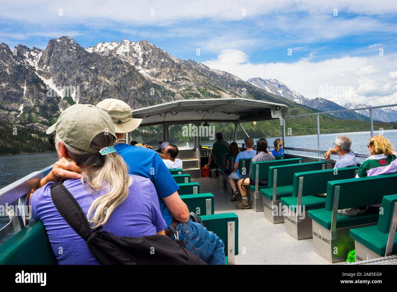People riding the Ferry Boat on Jenny Lake with the Teton Range behind