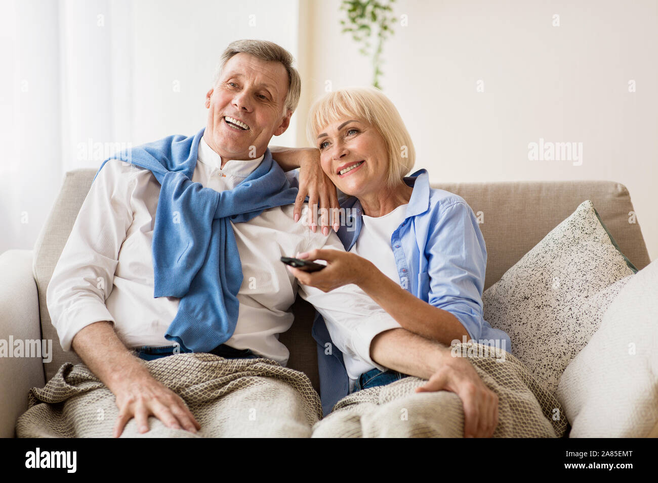 Beautiful mature woman watching tv hi-res stock photography and images ...
