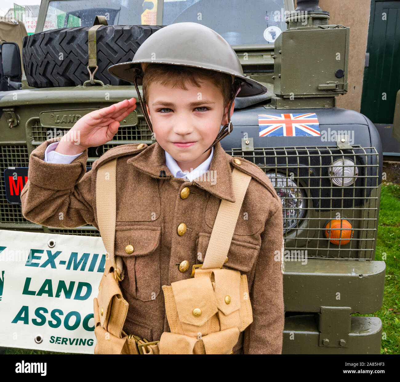 National airshow, East Fortune, East Lothian, Scotland, UK. Harrison aged 8 years in World War I soldier's army uniform makes a salute Stock Photo