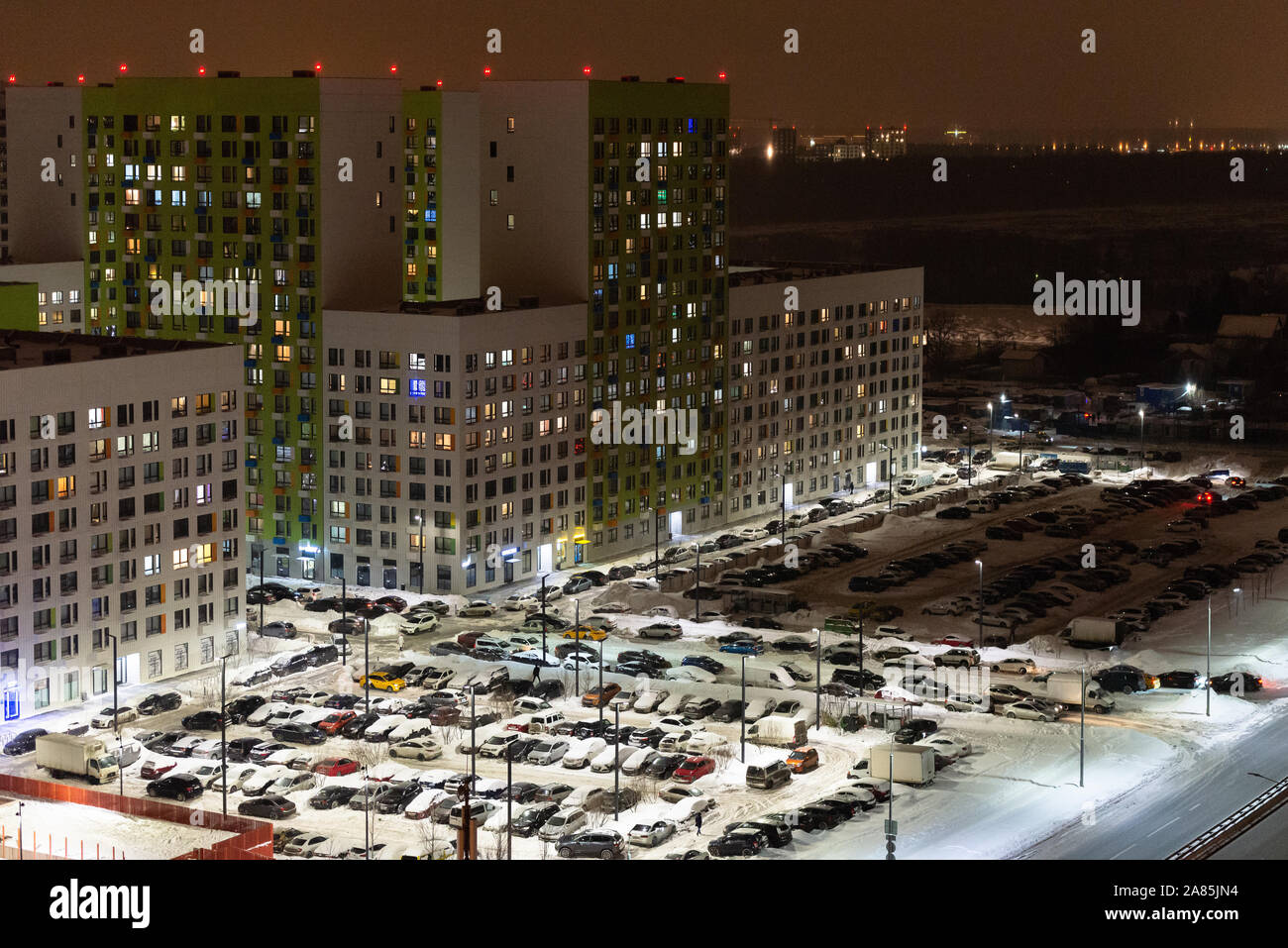 Moscow. December 2018. Dormitory suburb  of Moscow. Residential buildings with a parking lot at night in the light of lanterns. Stock Photo