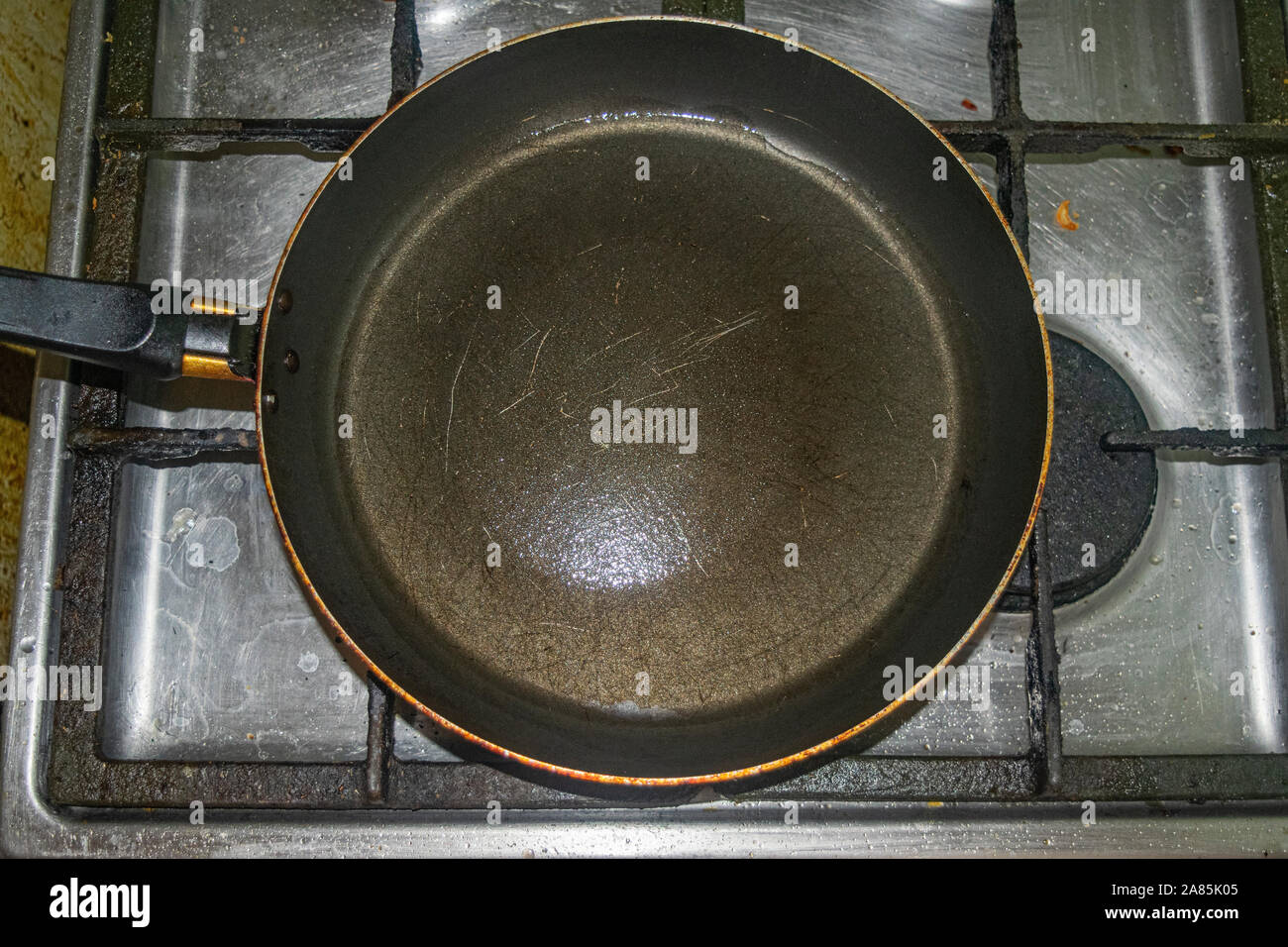 Nonstick frying pan on stainless steel gas stove. Home cooking Stock