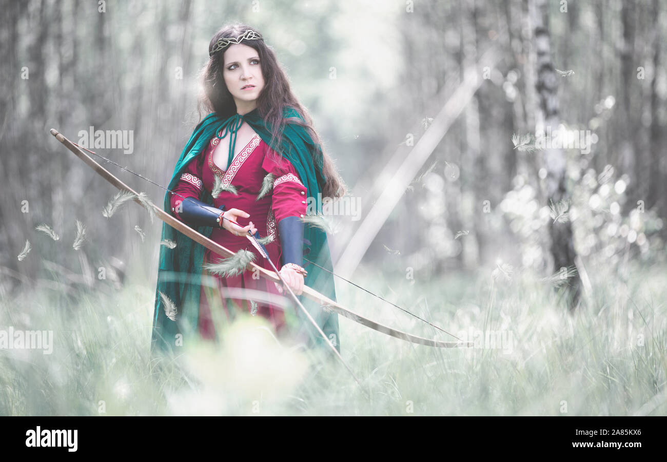 An elf archer with a bow in the woods Stock Photo