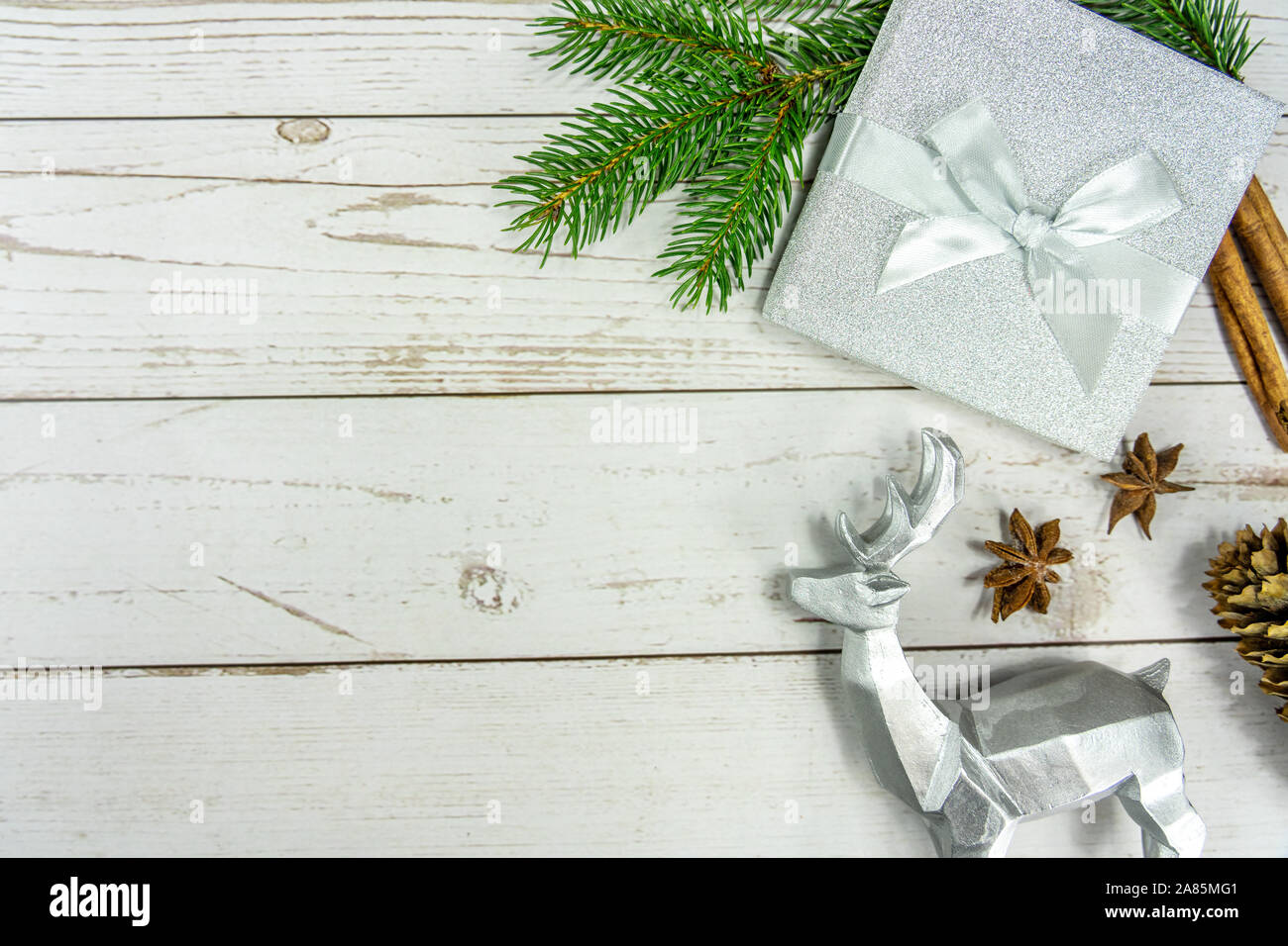 Christmas frame background on white wood with silver and natural decoration Stock Photo