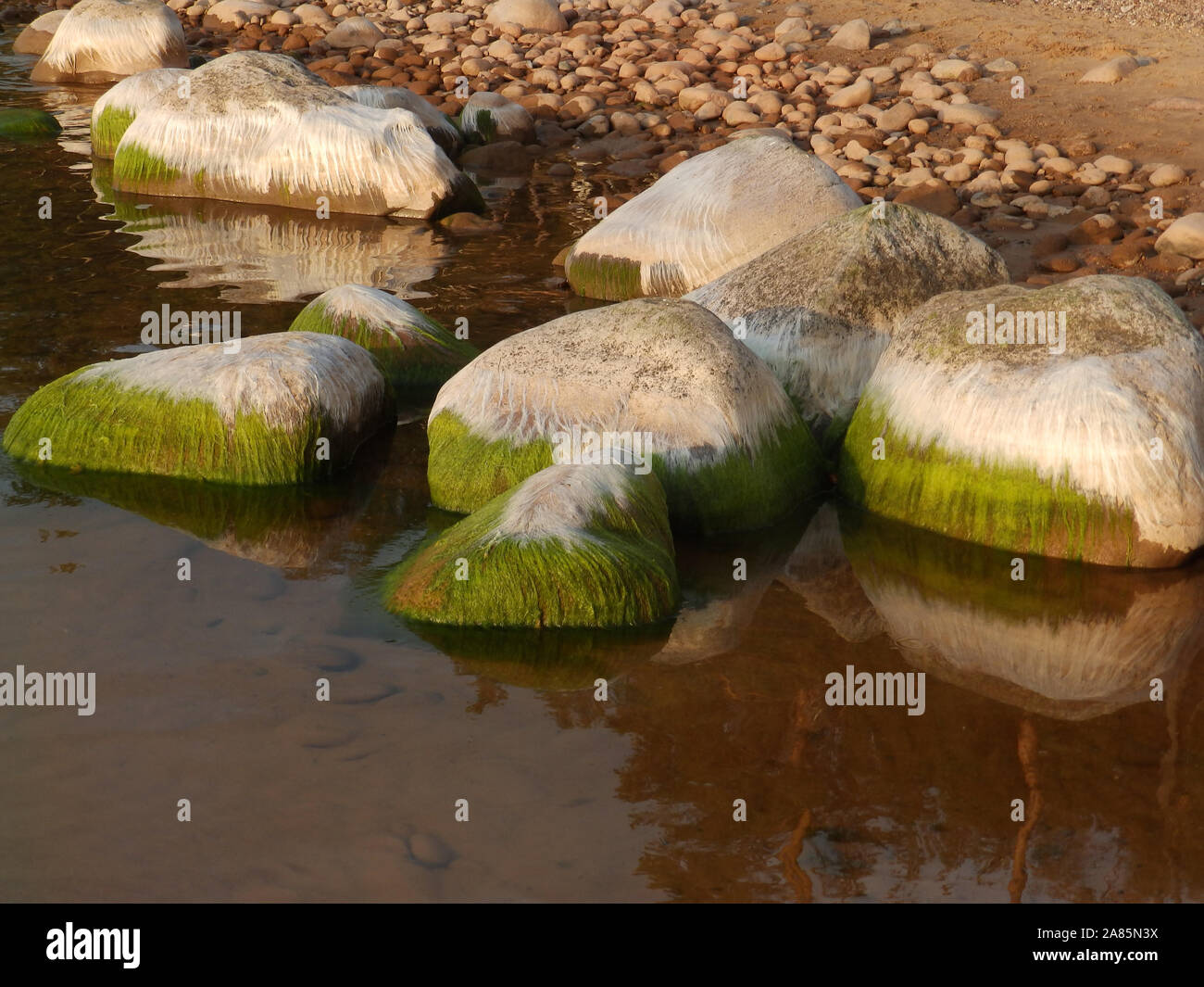 landscape with beautiful rocks by the sea, colorful reflections in the ...