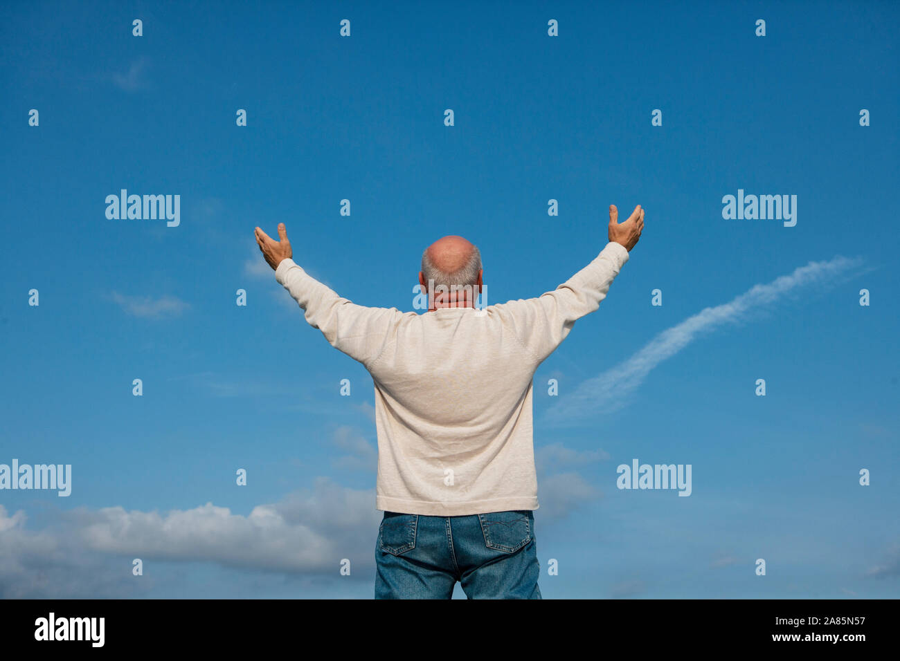 Back view of senior man holding his arms up Stock Photo Alamy