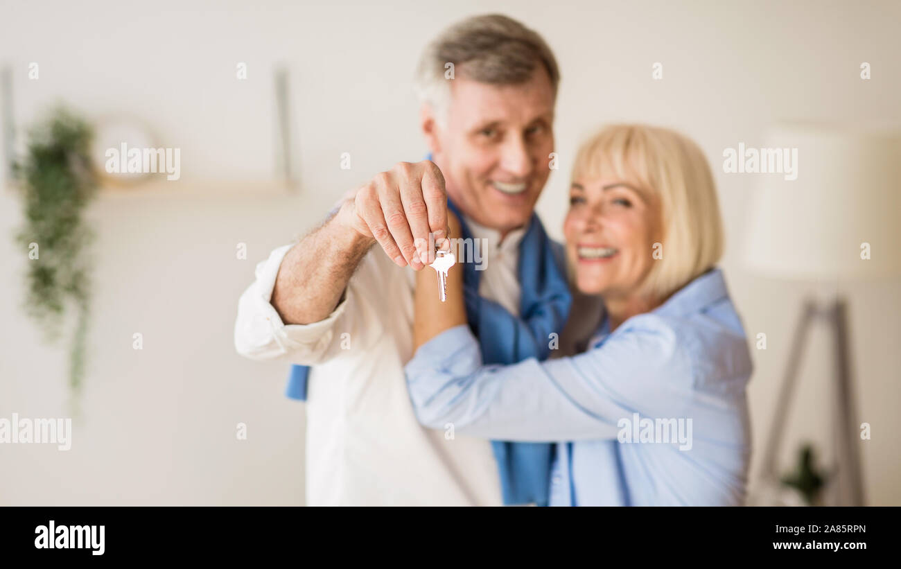 Senior couple moving into new home, man showing keys Stock Photo - Alamy