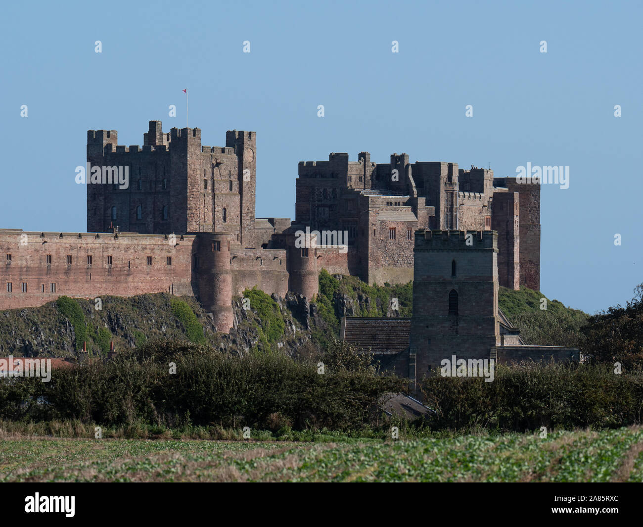 Distant view from West of Bamburgh Castle Stock Photo