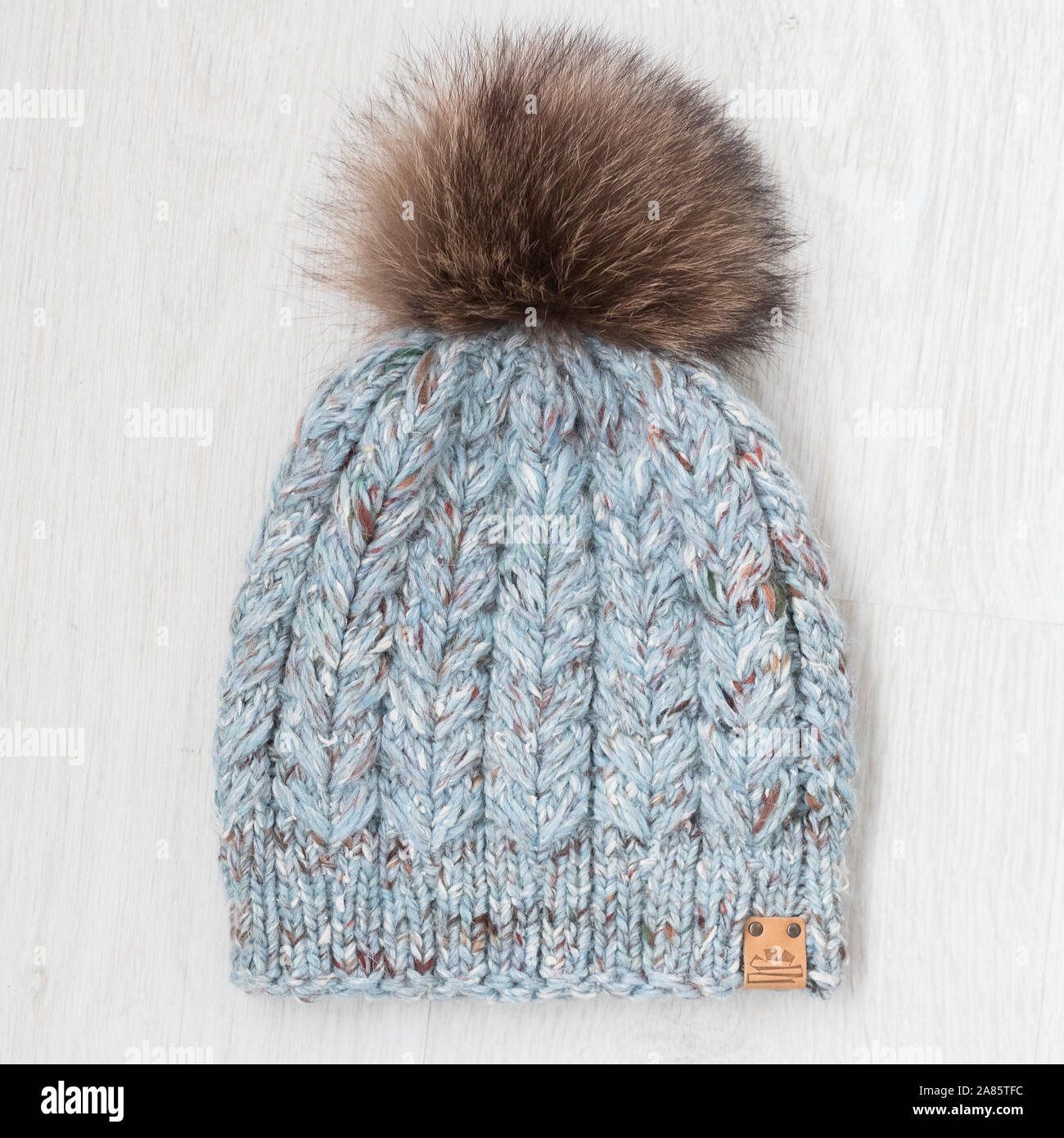 knit winter hat with fur pom Stock Photo