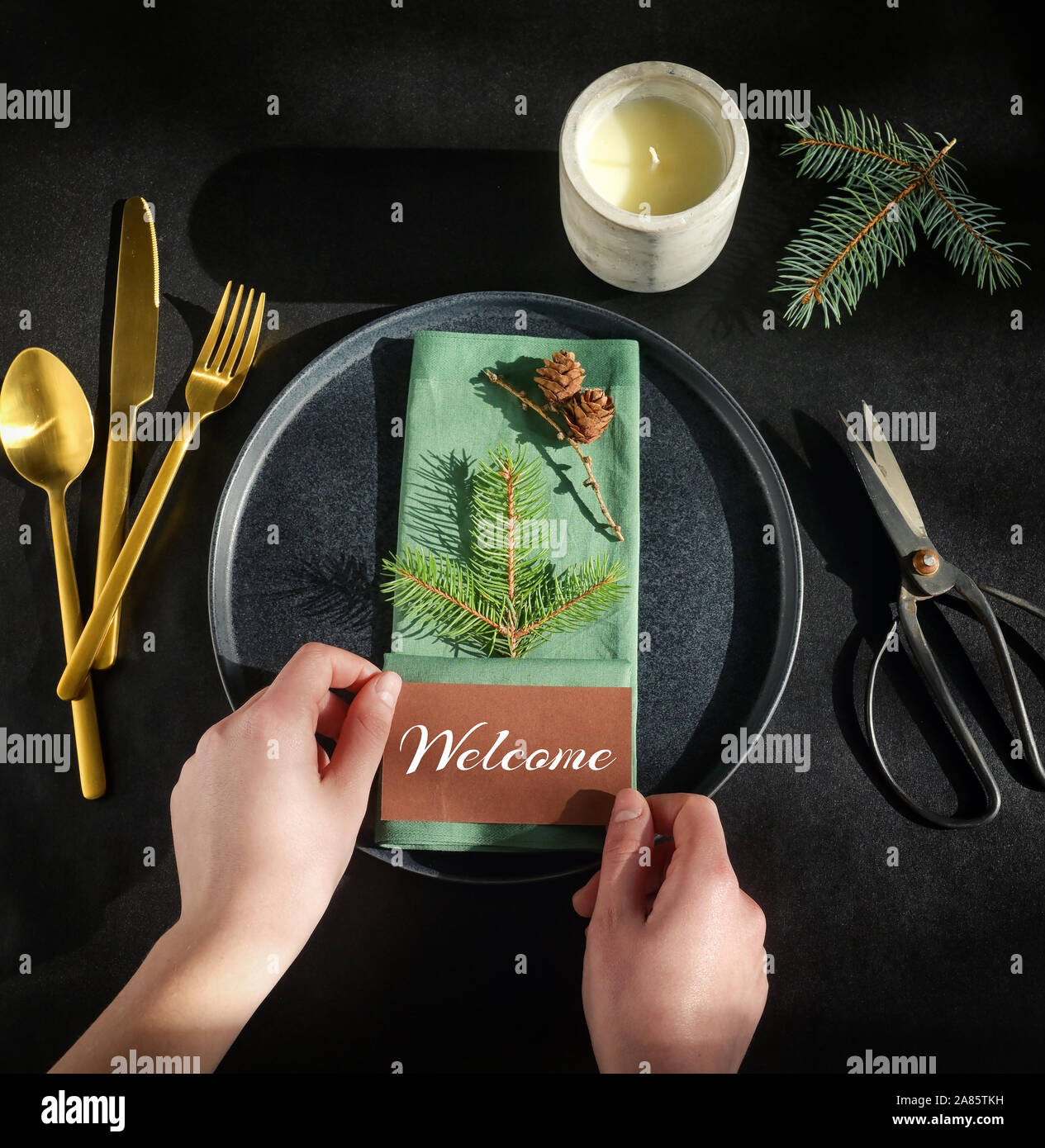 Setting A Holiday Dinner Table on Black Background Stock Photo