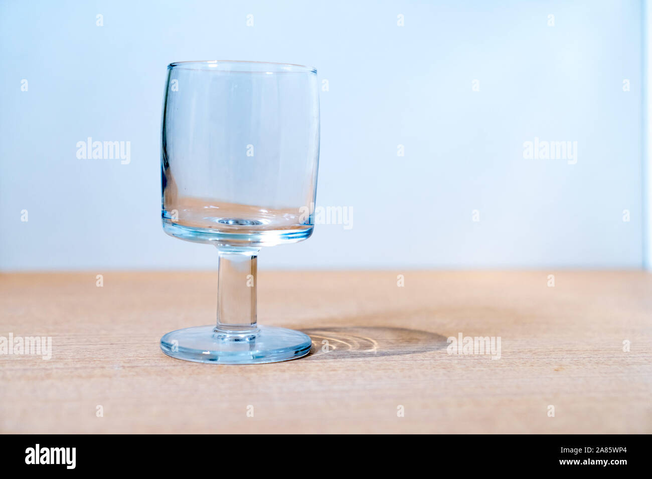 An empty glass goblet on the table Stock Photo