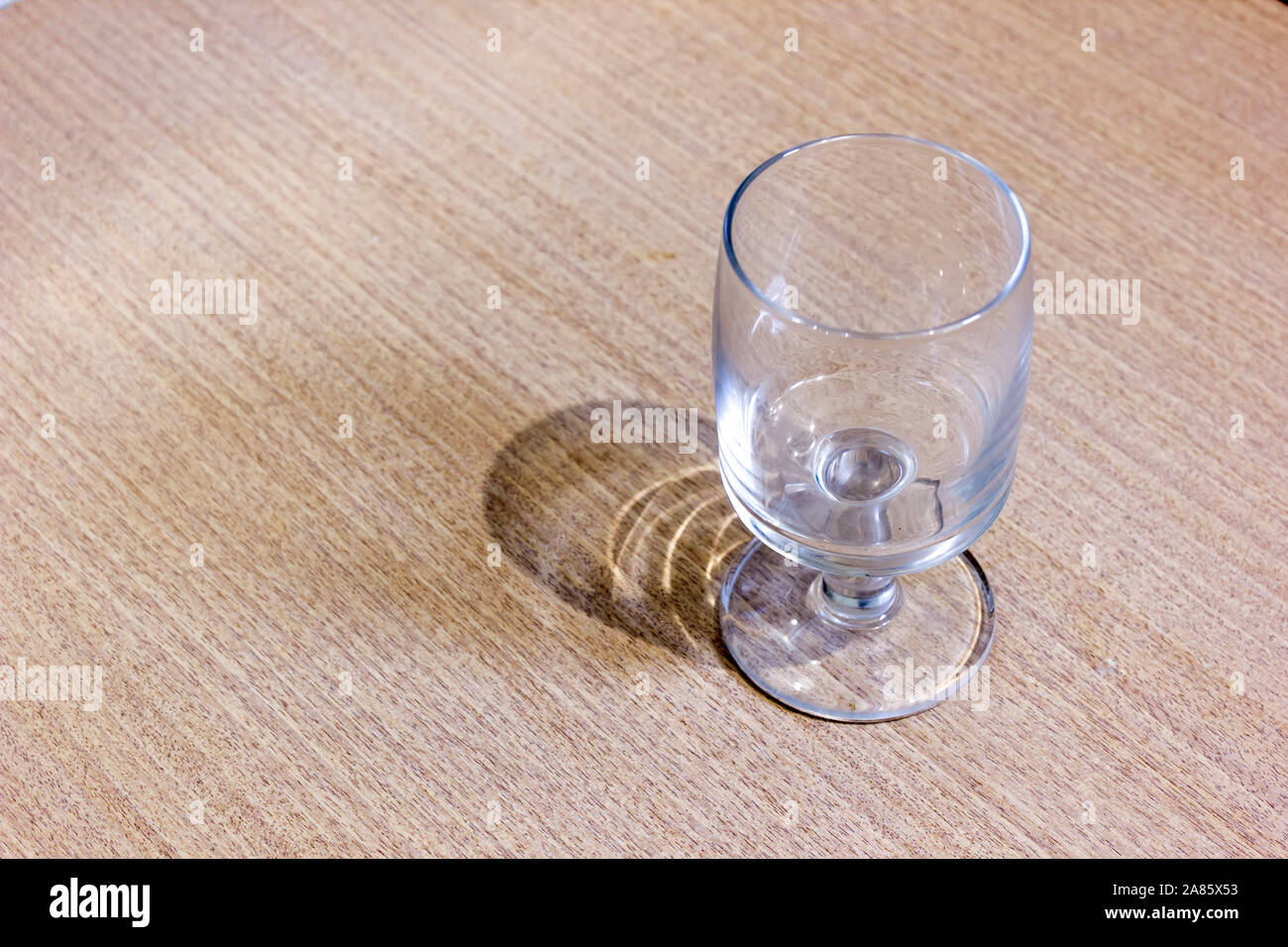 An empty glass goblet on the table Stock Photo