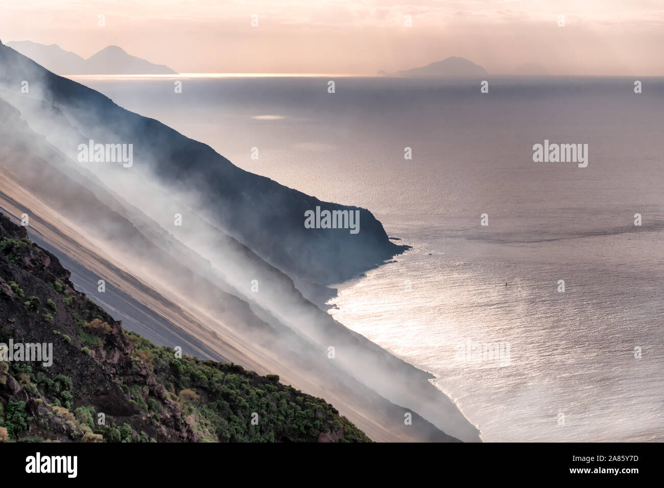 lava smoke on the north west side 'sciara del fuoco'  of the stromboli vucano, aeolian islands, Italy at end of day. Stock Photo