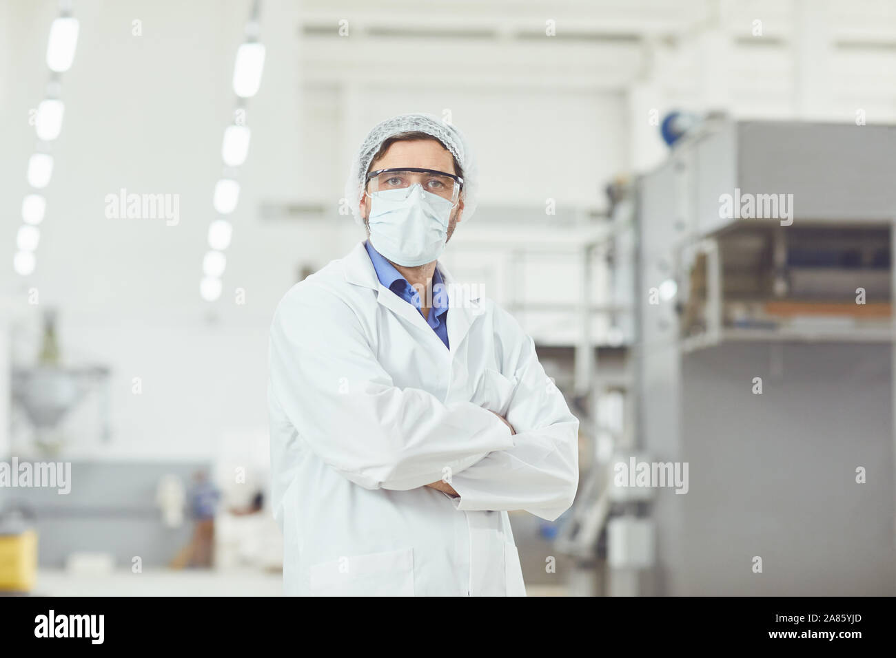 Technologist in a mask at work. Stock Photo