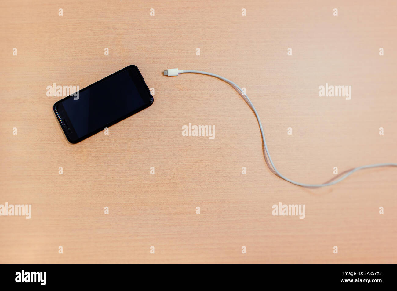 USB cable about to enter the smartphone Stock Photo