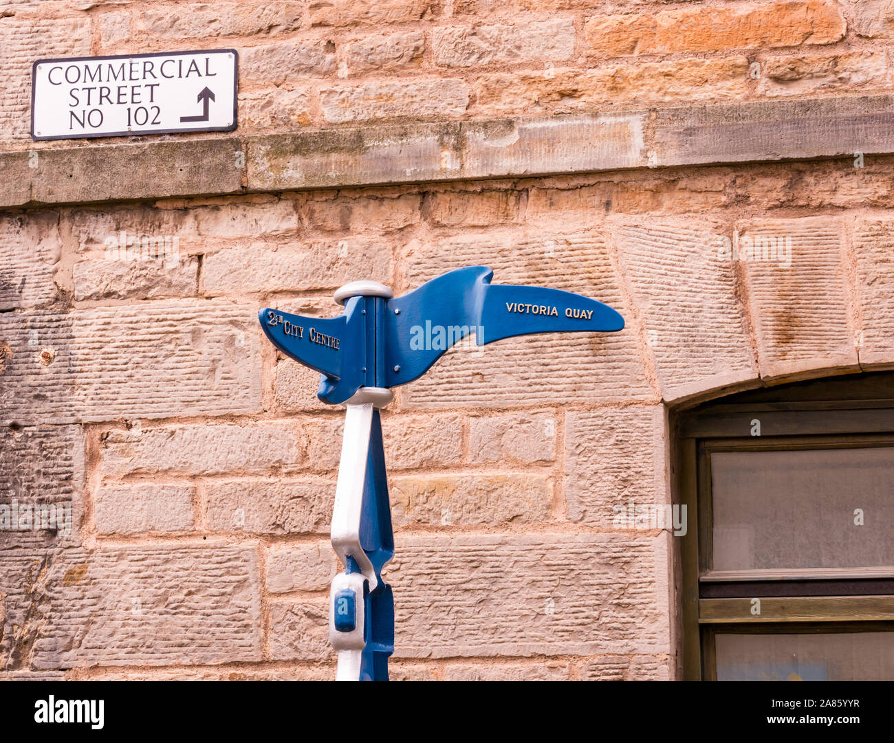 Quirky directions signpost to Victoria Quay and city centre, Commercial Street, Leith, Edinburgh, Scotland, UK Stock Photo