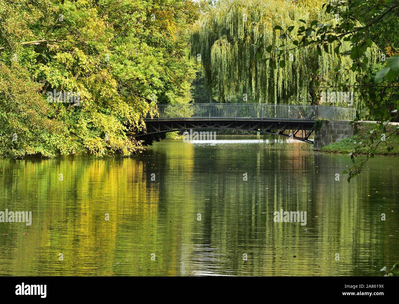 Bridge in Laxenburg palace park and trees reflected on an autumn day. Stock Photo