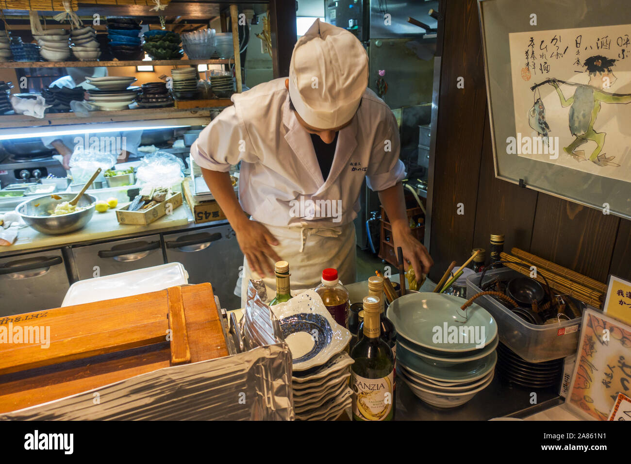 Kyoto, Japan - October 29th, 2019: Chef cooking inside a Izakaya, a sort of after work casual dining place. Stock Photo