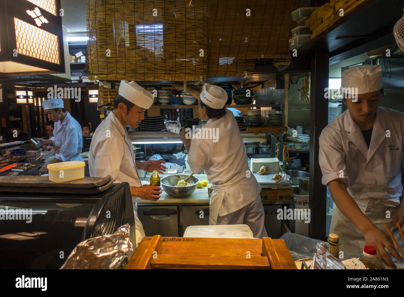 Kyoto, Japan - October 29th, 2019: Chef cooking inside a Izakaya, a sort of after work casual dining place. Stock Photo