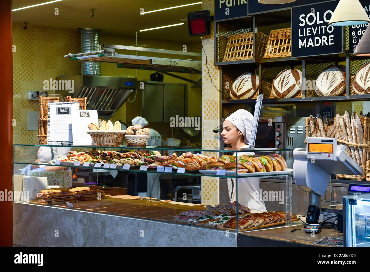 Counter of a bakery with bread, pizza and focaccia displayed at San Lorenzo Central Market in the historic centre of Florence, Tuscany, Italy Stock Photo