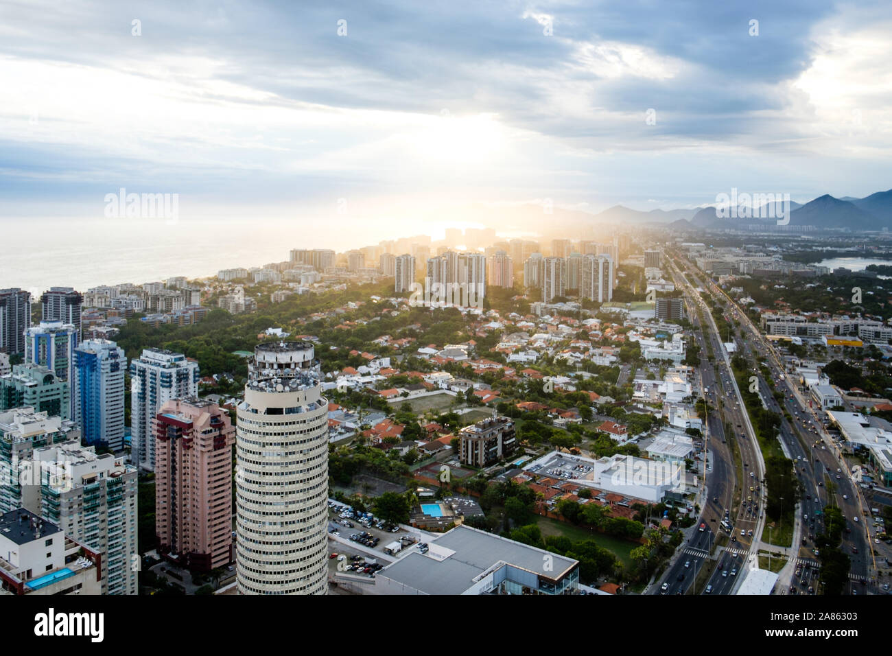 Sunlight breaking through clouds over cityscape of Rio de Janeiro Stock Photo