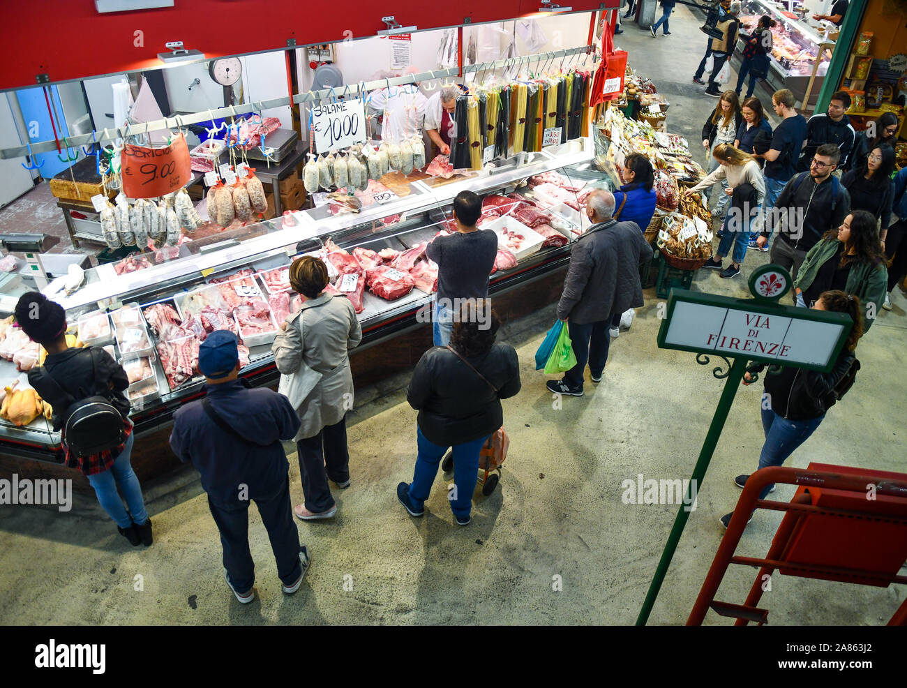 High angle view of the crowded counter of a butchery at the ground floor of San Lorenzo Central Market in the city centre of Florence, Tuscany, Italy Stock Photo