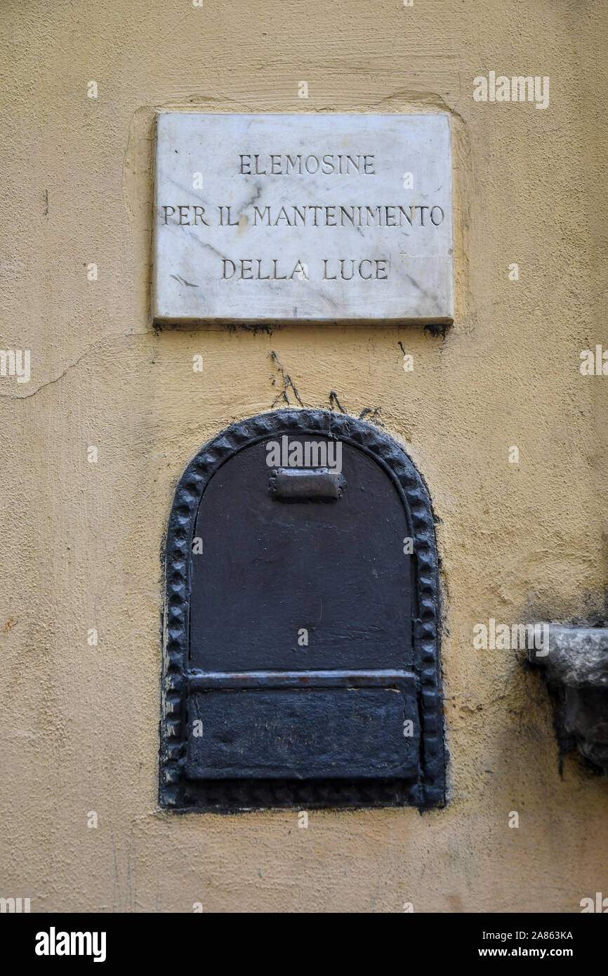 Close-up of an old alms box on the exterior wall of a religious building in the historic centre of Florence, Tuscany, Italy Stock Photo