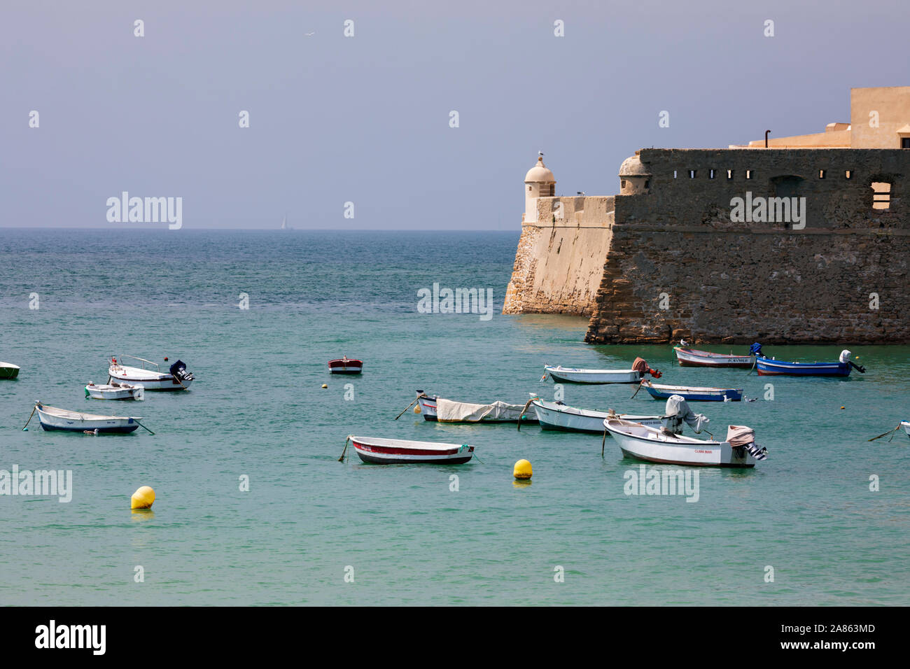 Boats moored below the walls of the Castillo de Santa Catalina, Cadiz, Andalucia, Spain, Europe Stock Photo