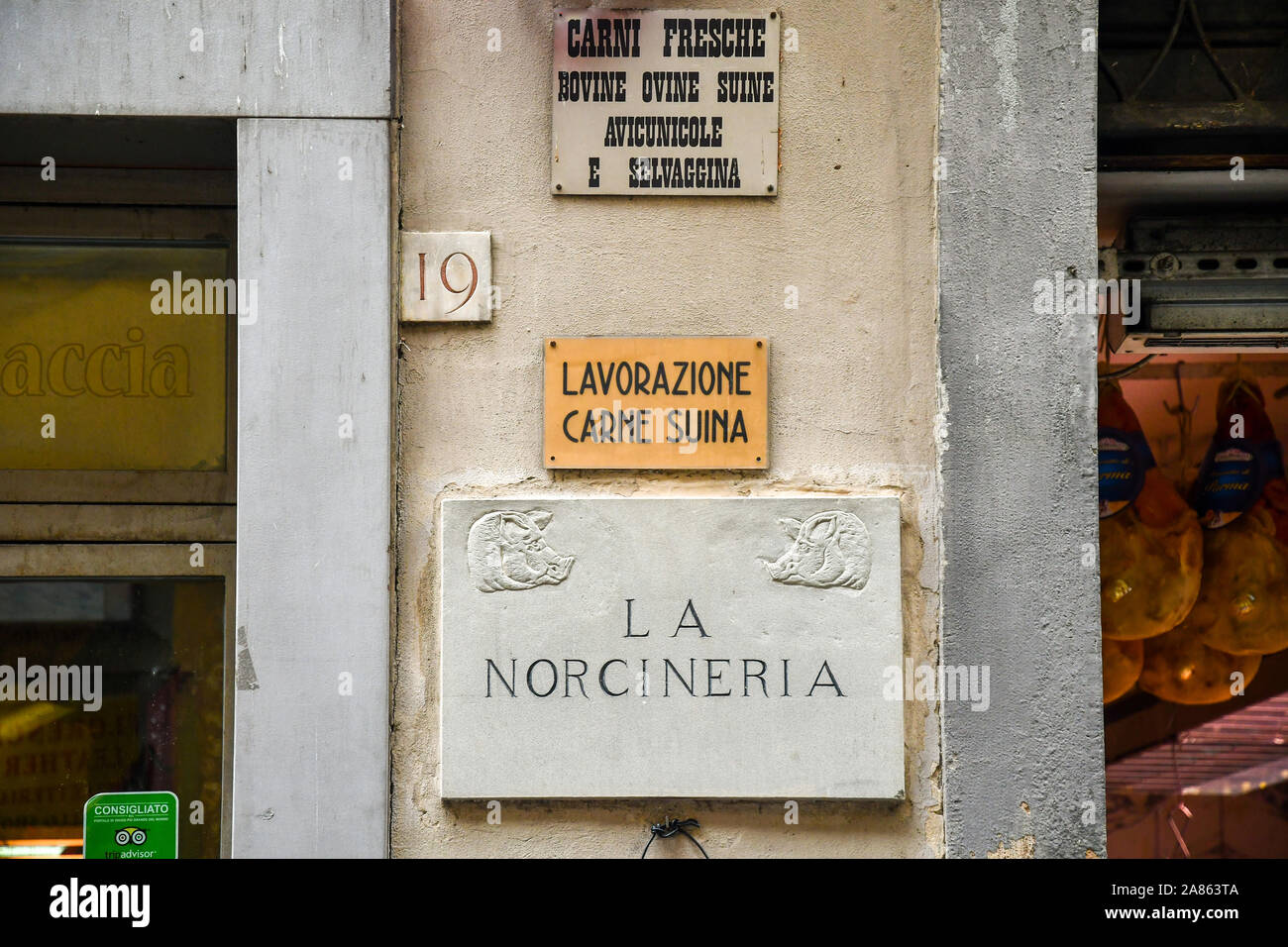 Exterior wall with the sign of La Norcineria butchery and delicatessen shop selling local pigmeat in the historic centre of Florence, Tuscany, Italy Stock Photo