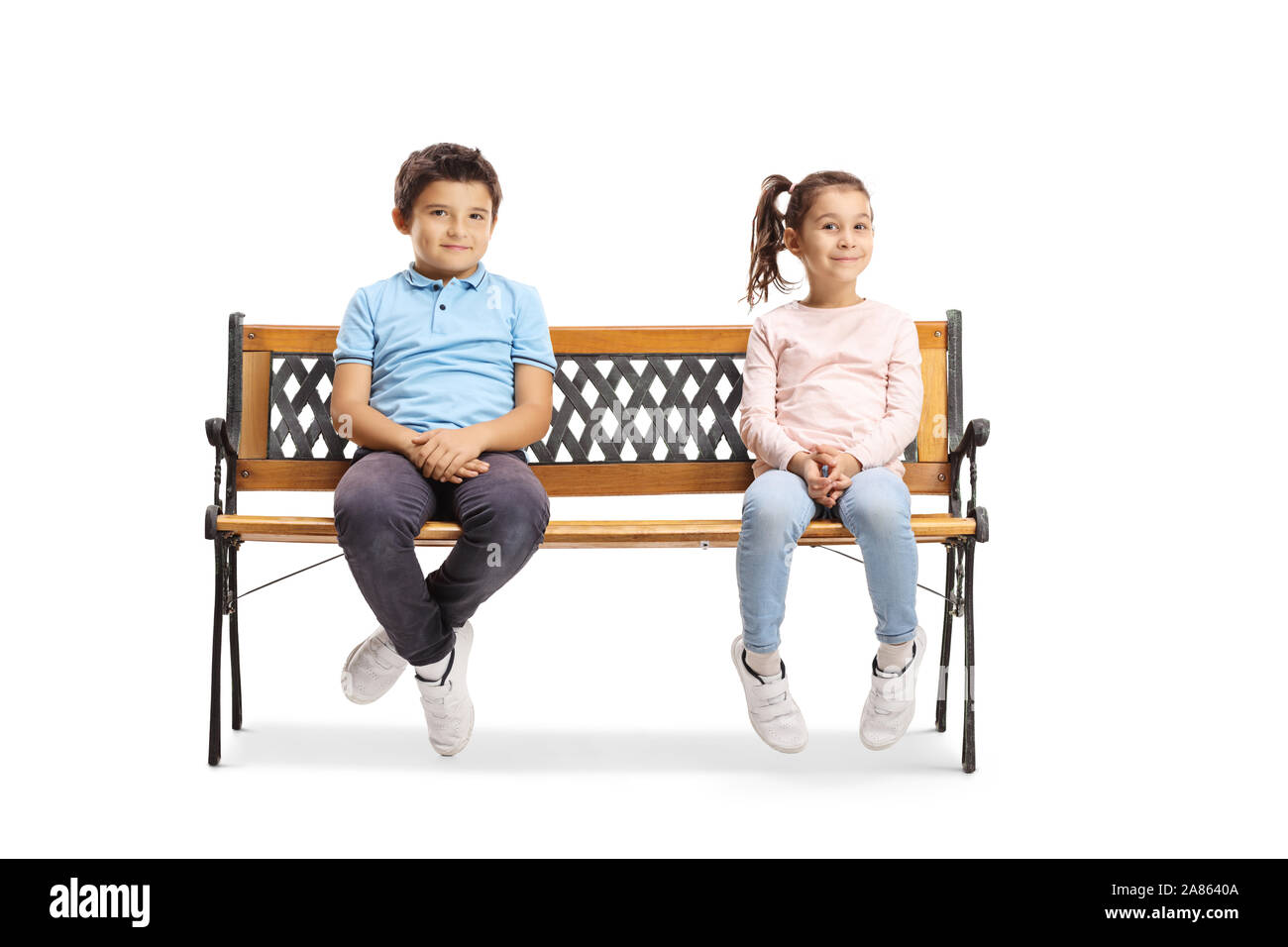 Full length portrait of a boy and girl sitting on a bench and smiling ...