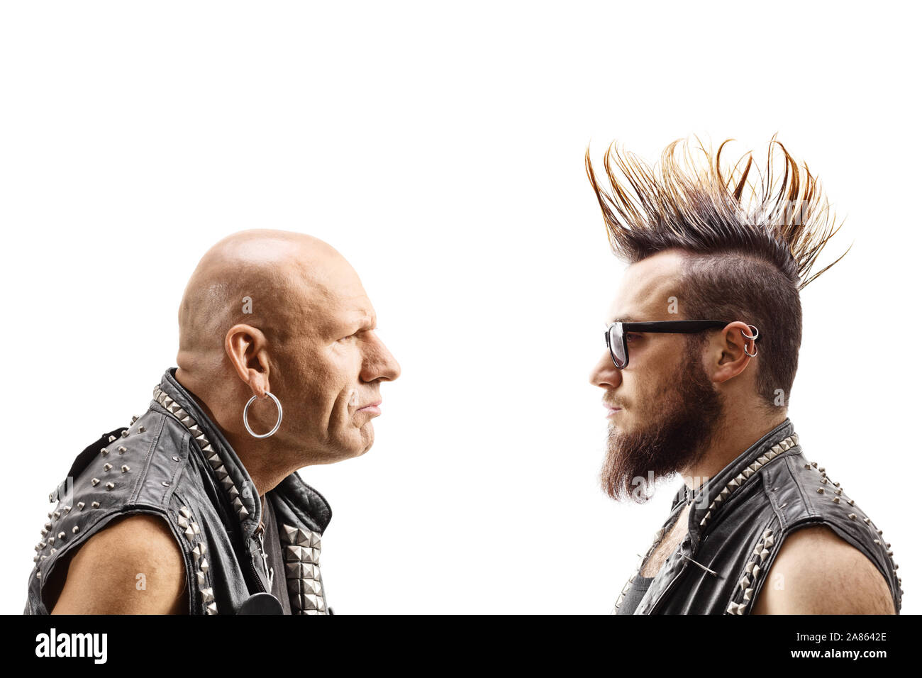 Young punker with a mohawk and an older bald punker looking at each other isolated on white background Stock Photo