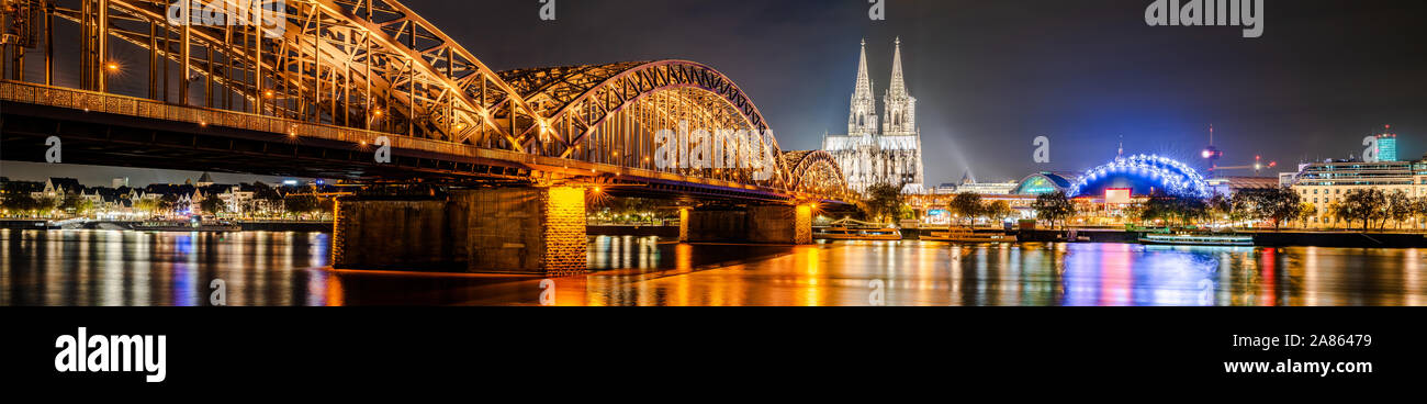 Panorama of the city of Cologne at night with Cologne Cathedral, Hohenzollern Bridge and Rhine river Stock Photo