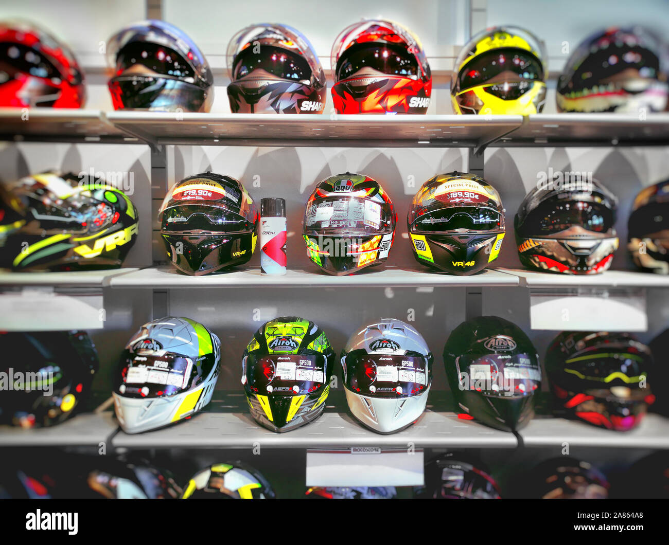 motorbike sports helmets on the shelves of a specialized shop Stock Photo