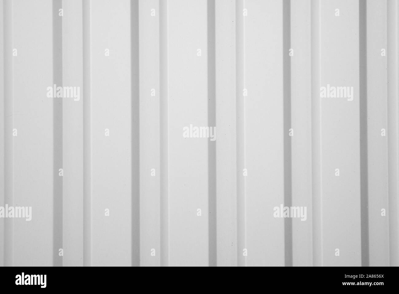 Corrugated metal sheet painted in gray paint. Seamless textured background.  Siding. Modern fence with vertical stripes. Stock Photo