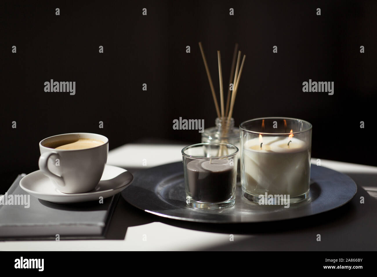 coffee, candles and aroma reed diffuser on table Stock Photo