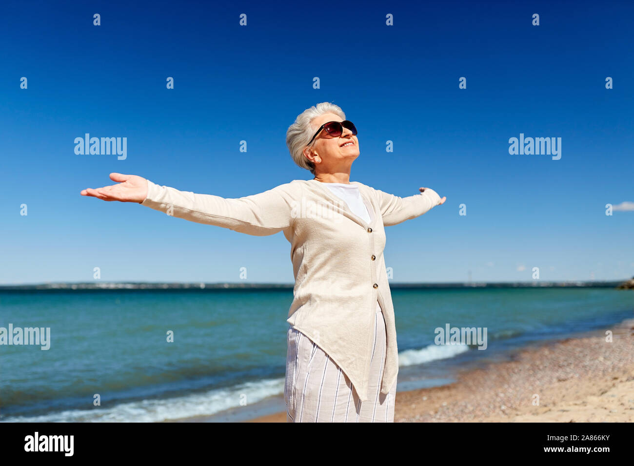 portrait of senior woman in sunglasses on beach Stock Photo - Alamy