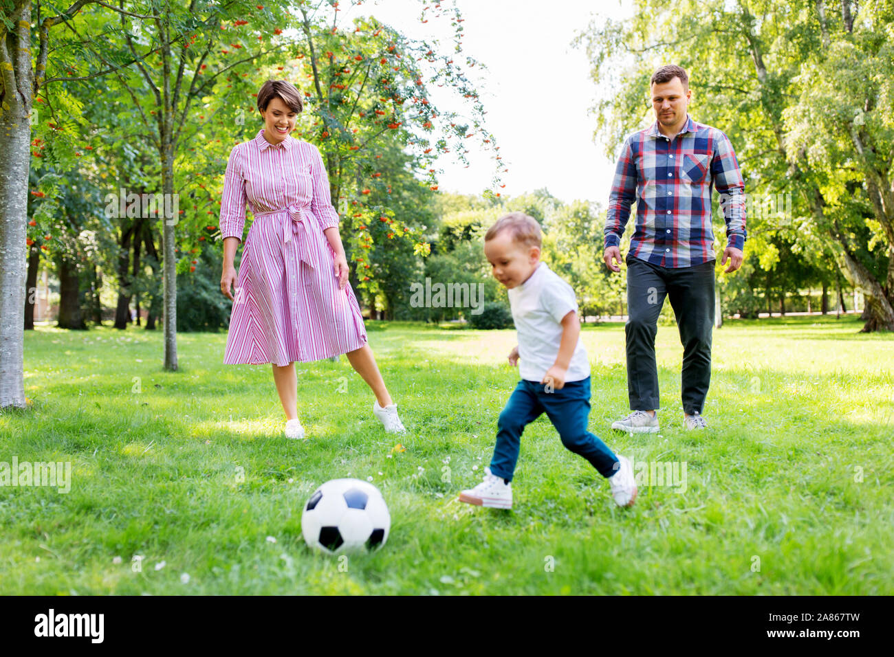 happy family playing soccer at summer park Stock Photo - Alamy