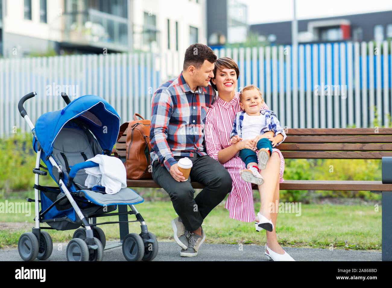 family with baby in stroller and coffee in city Stock Photo Alamy