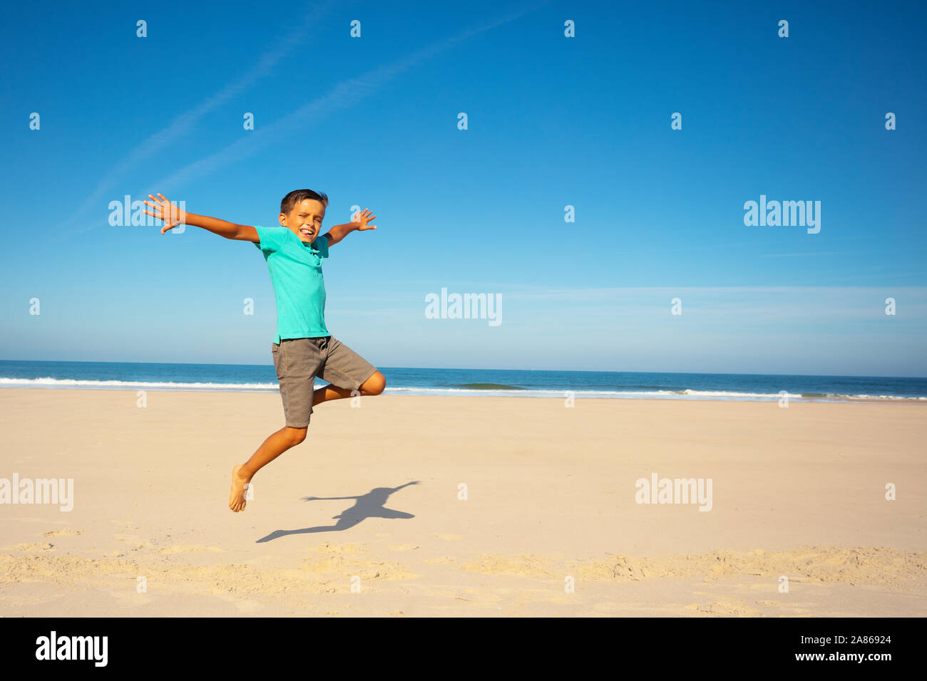 Happy boy jump on a sea sand beach portrait Stock Photo Alamy