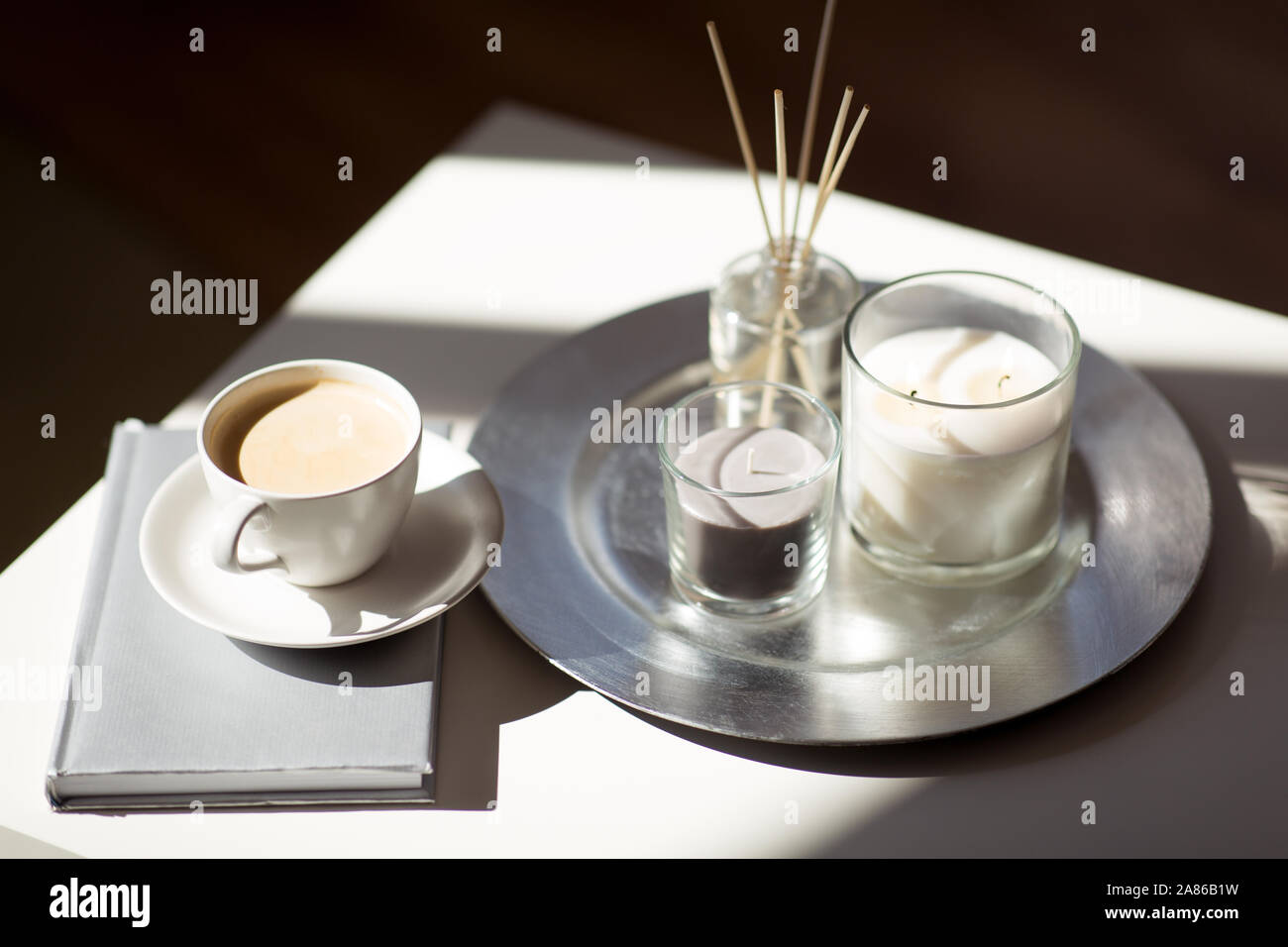 coffee, candles and aroma reed diffuser on table Stock Photo