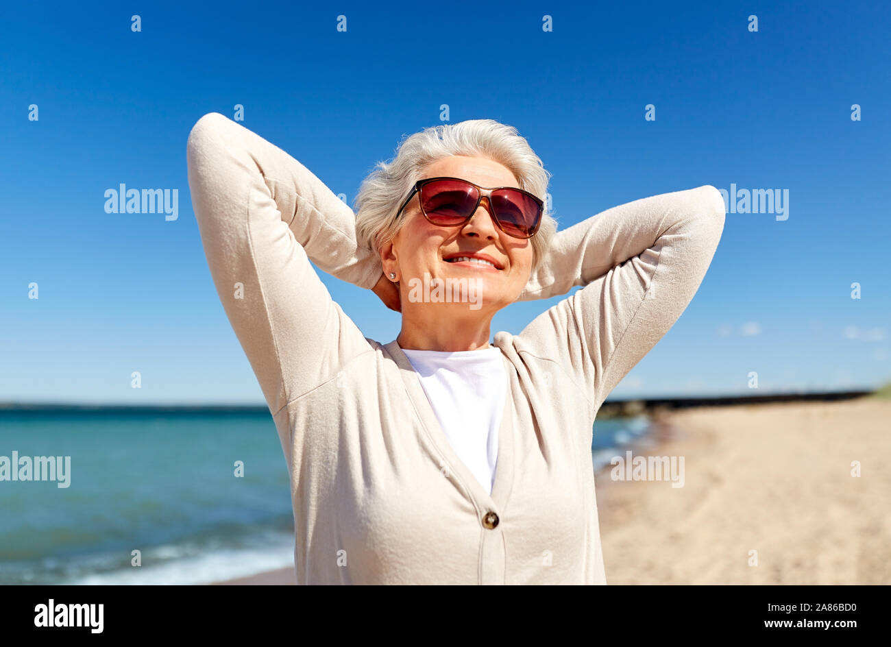 portrait of senior woman in sunglasses on beach Stock Photo - Alamy