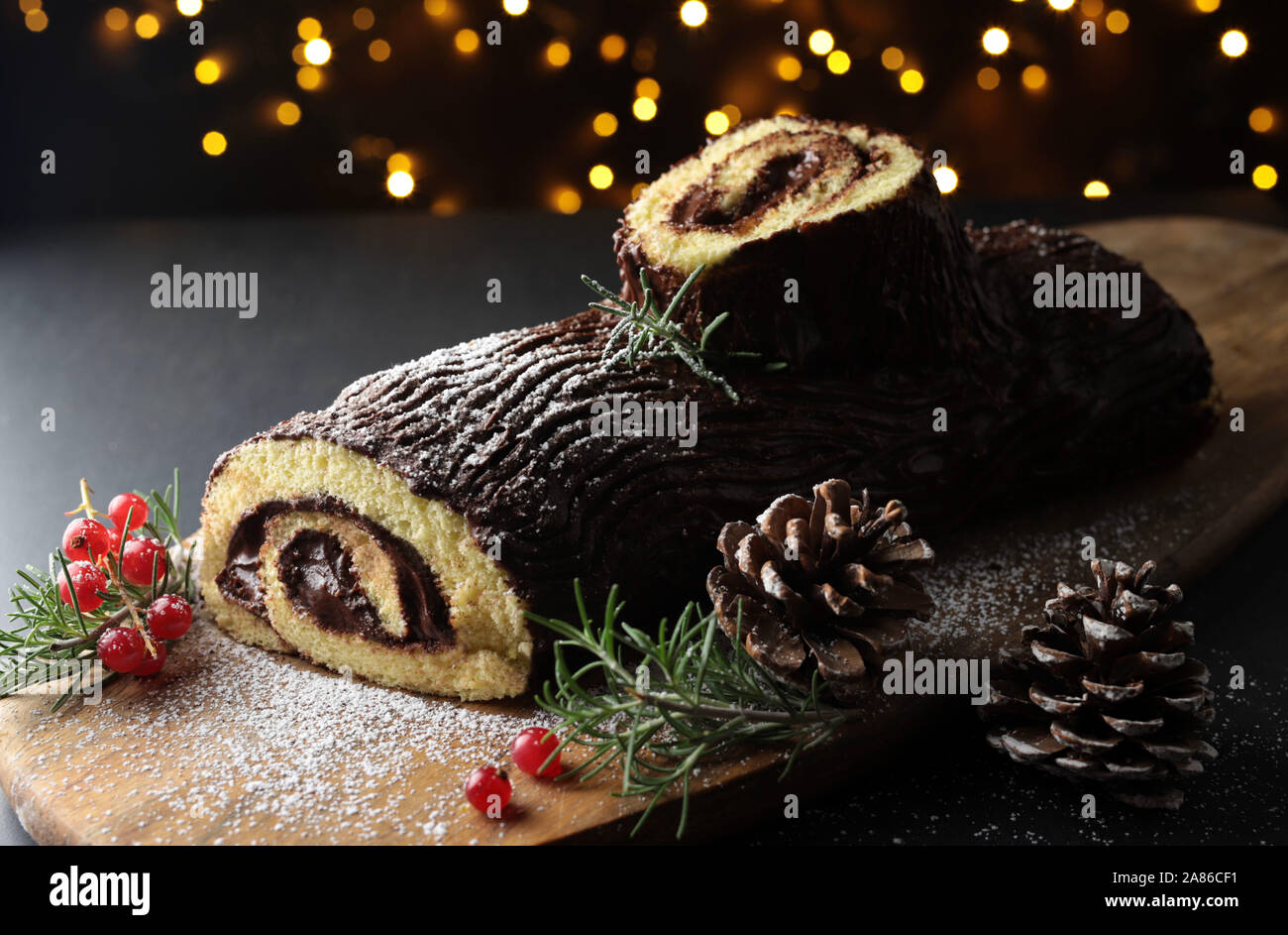 Chocolate Christmas Yule Log, Buche de Noel on wooden cutting board