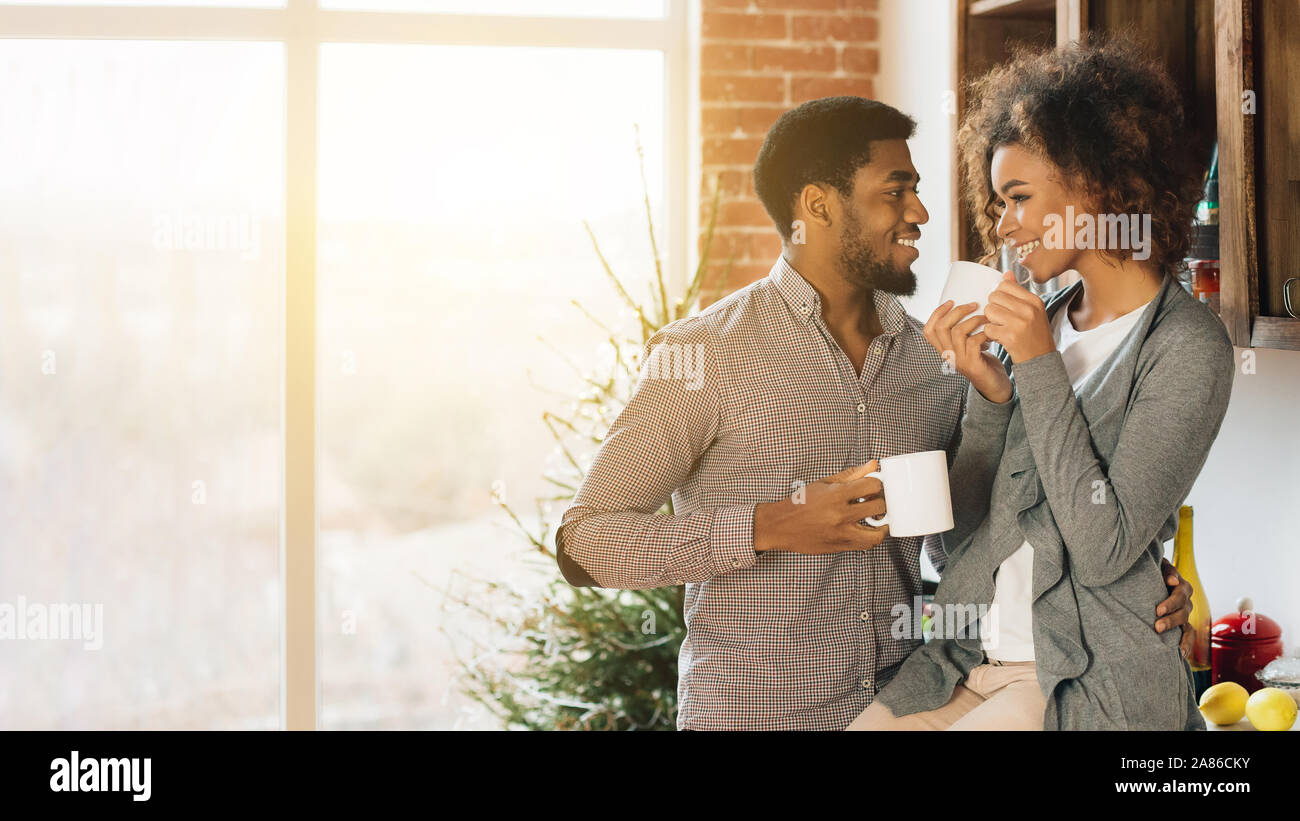African-american couple drinking coffee in kitchen together Stock Photo ...