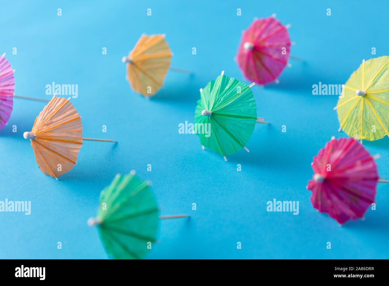 cocktail umbrellas on blue background Stock Photo