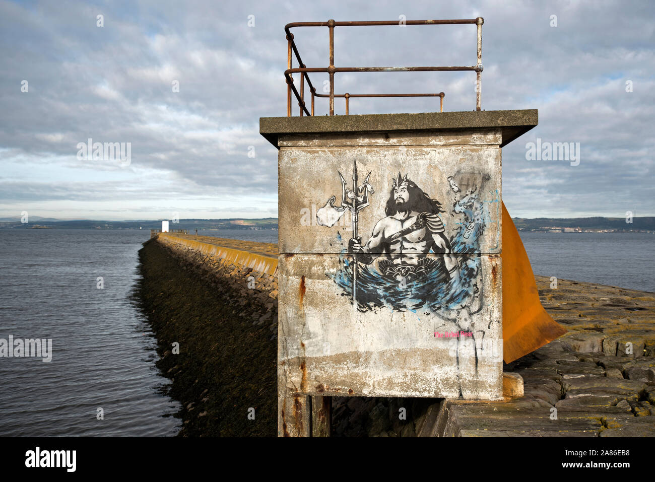 Stencil graffiti showing Neptune with plastic bags caught on his trident, on the breakwater at Granton Harbour, Edinburgh, Scotland, UK. Stock Photo