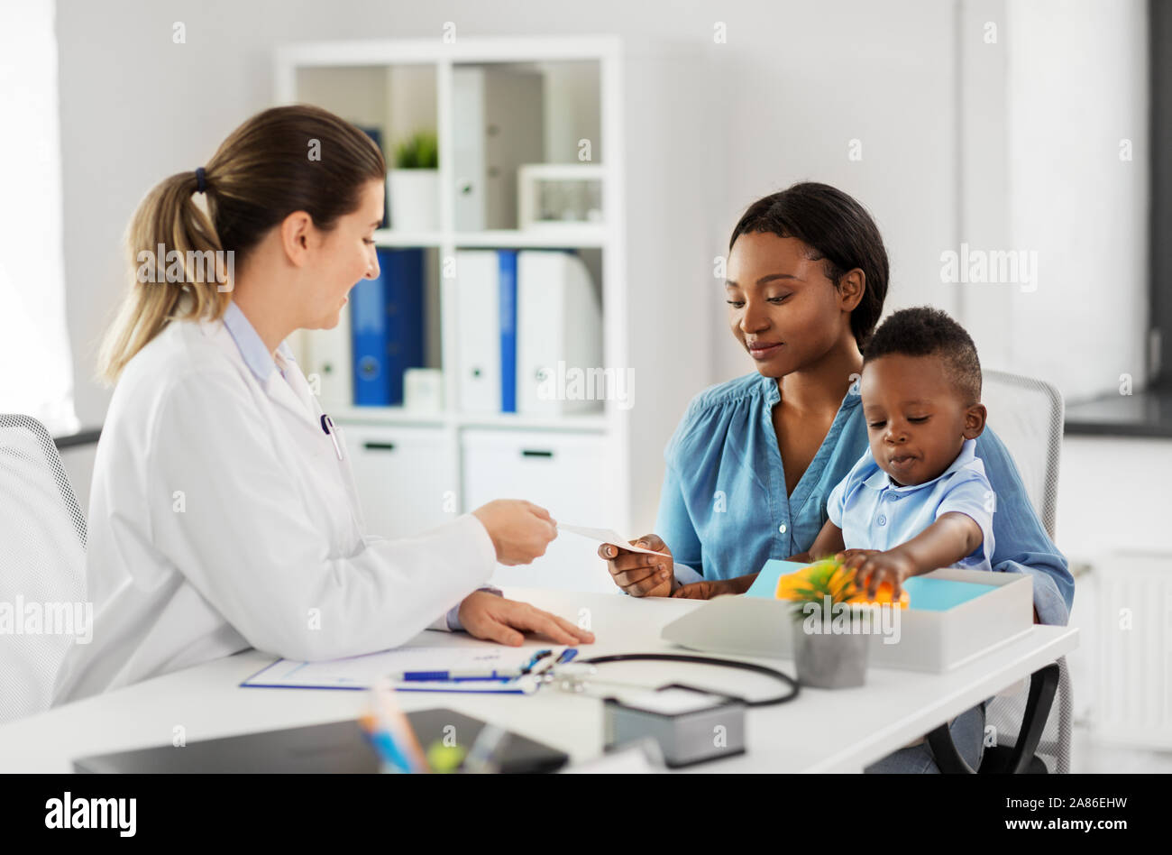 happy mother with baby son and doctor at clinic Stock Photo - Alamy